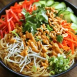 - 8 ounces rice noodles - 1 cup shredded carrots - 1 red bell pepper, thinly sliced - 1 cucumber, julienned - 1 cup bean sprouts - 1/2 cup chopped scallions - 1/2 cup roasted peanuts, chopped - Fresh cilantro for garnish For the peanut sauce, you will need: - 1/2 cup creamy peanut butter - 1/4 cup soy sauce - 2 tablespoons rice vinegar - 2 tablespoons maple syrup or honey - 1 tablespoon sesame oil - 1 tablespoon ginger, minced - 2 cloves garlic, minced - 1-2 tablespoons sriracha (adjust to taste) - Water as needed to thin the sauce These ingredients come together to create a delicious dish. The rice noodles are the base, offering a soft and chewy texture. Fresh vegetables add crunch and color, making your plate pop. The peanut sauce ties everything together with its rich and creamy flavor. - Chopped roasted peanuts - Fresh cilantro - Lime wedges for serving These garnishes add fun and flair to your dish. The chopped peanuts give extra crunch. Fresh cilantro brightens the flavors. Lime wedges offer a zesty kick. Feel free to mix and match these toppings to suit your taste. For the full recipe, you can find all the steps and tips you need. First, you need 8 ounces of rice noodles. Boil water in a large pot. Once it boils, add the noodles. Cook them for about 3 to 5 minutes. Stir often to prevent sticking. When they are soft, drain them. Rinse the noodles in cold water. This stops the cooking. Set the noodles aside to cool. In a medium bowl, add 1/2 cup of creamy peanut butter. Then, pour in 1/4 cup of soy sauce. Next, add 2 tablespoons of rice vinegar and 2 tablespoons of maple syrup or honey. Then, mix in 1 tablespoon of sesame oil, 1 tablespoon of minced ginger, and 2 cloves of minced garlic. If you like heat, add 1-2 tablespoons of sriracha. Whisk all the ingredients together until smooth. If the sauce is too thick, add a bit of water until it reaches your desired consistency. In a large mixing bowl, combine the noodles with 1 cup of shredded carrots, 1 sliced red bell pepper, 1 julienned cucumber, 1 cup of bean sprouts, and 1/2 cup of chopped scallions. Pour the peanut sauce over the mixture. Toss everything gently until the noodles and veggies are evenly coated. Serve the Thai Peanut Noodles in bowls. Top with chopped roasted peanuts and a sprinkle of fresh cilantro. Enjoy your meal! For more detailed steps, check the Full Recipe. To cook rice noodles just right, follow the package instructions. Usually, they need 6-8 minutes in boiling water. Check them often to avoid overcooking. Once they are soft, drain and rinse them with cold water. This stops the cooking process and keeps them from getting mushy. To make your peanut sauce pop, add a dash of garlic powder or red pepper flakes. These spices can boost the taste. If you like heat, try more sriracha or fresh chili. Start small, then add more if needed. This way, you can find the perfect balance for your taste. When serving, place the noodles in a bowl and top them with fresh veggies. Sprinkle chopped roasted peanuts on top for crunch. Add a few sprigs of cilantro for color. Arrange lime wedges around the bowl for a bright touch. This makes your dish look fun and inviting. {{image_2}} You can add protein to your Thai peanut noodles for more flavor and nutrition. - Tofu or Tempeh Options: Tofu is a great choice for a plant-based meal. Use firm tofu, cut into cubes. Pan-fry until golden for extra crunch. Tempeh is another option. Slice it thin and sauté to get a nice texture. Both absorb the peanut sauce well, making them flavorful. - Chicken or Shrimp Variations: Chicken adds a hearty touch. Grill or sauté it before mixing with the noodles. Shrimp cooks quickly and gives a nice seafood flavor. Just toss them in a hot pan until they turn pink. Both options make the dish more filling. You can change the vegetables based on what you have or like. - Seasonal Vegetable Ideas: Try using zucchini, snap peas, or bell peppers. They add freshness and crunch. In the fall, add roasted sweet potatoes. They pair well with the peanut sauce. - Colorful Alternatives: The more colors, the better! Carrots, red cabbage, and radishes add a pop of color. Not only do they look good, but they also boost nutrition and flavor. You can tweak the peanut sauce to fit your taste or needs. - Nut-Free Alternatives: If you have nut allergies, use sunflower seed butter. It has a similar texture and flavor. You could also try tahini for a different taste. - Flavor Infusions: Want a creamier sauce? Add coconut milk. It gives a wonderful richness. You can also add lime juice for a zesty kick. Adjust the sriracha for heat, if you like it spicy. For the full recipe, check out the [Full Recipe]. To keep your Thai Peanut Noodles fresh, store them in an airtight container. Glass or plastic containers work well. Make sure to cool the noodles completely before sealing the container. This helps prevent sogginess. You can store the noodles in the fridge for up to three days. If you want to keep them longer, consider freezing. They can last up to three months in the freezer. Just remember to separate the sauce to keep it fresh. When it's time to eat your noodles again, reheating is simple. The best method is to use a microwave. Place the noodles in a bowl and cover them with a damp paper towel. Heat in short intervals, stirring in between. This helps heat evenly. Alternatively, you can reheat them on the stove. Add a splash of water or extra sauce to a pan. Heat over low to medium heat, stirring until warm. After reheating, serve with fresh toppings. Chopped peanuts and cilantro add great flavor. Enjoy your quick meal! Thai peanut noodles last about three to four days in the fridge. Store them in a sealed container. Always check for freshness before eating. Yes, you can make the peanut sauce ahead of time. Store it in the fridge for up to one week. Just mix it well before using. If it thickens, add a bit of water to thin it out. You can serve Thai peanut noodles with many sides. Try spring rolls for a light snack. A crunchy salad pairs well too. Grilled chicken or shrimp also makes a great addition. Yes, this recipe is great for meal prep. You can cook a batch for the week. Store the noodles and sauce separately. Combine them when you are ready to eat. This keeps everything fresh and tasty. Thai peanut noodles are a delicious mix of rice noodles, fresh veggies, and a tasty peanut sauce. You can add roasted peanuts, cilantro, and lime for extra flavor. Follow the steps to cook the noodles, make the sauce, and toss everything together. Use the tips to perfect your dish, try new proteins, and store leftovers properly. In conclusion, making this dish is fun and easy. Enjoy the taste and share it with friends. Make it yours by adding your favorite flavors!
